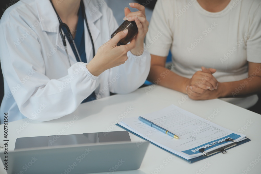 Doctor using sphygmomanometer with stethoscope checking blood pressure to a patient in the hospital. Doctor using sphygmomanometer with stethoscope checking blood pressure to a patient in the hospital.