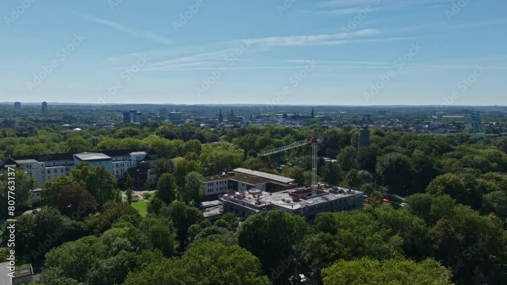 Aerial drone view of Bochum Park, also known as Stadtpark Bochum, featuring Fossilium Bochum Zoo. This spacious green space includes a boating pond and a zoo, offering a delightful blend of nature .