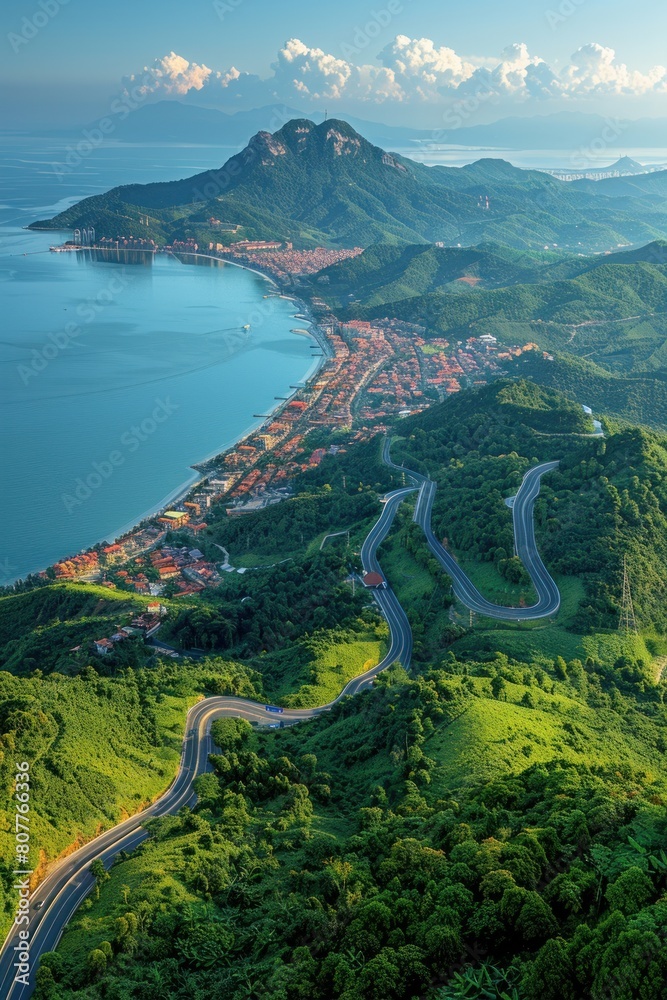 Aerial perspective of a winding road cutting through mountainous terrain