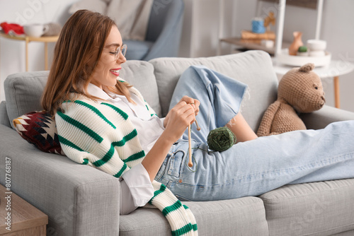 Young woman knitting with n...