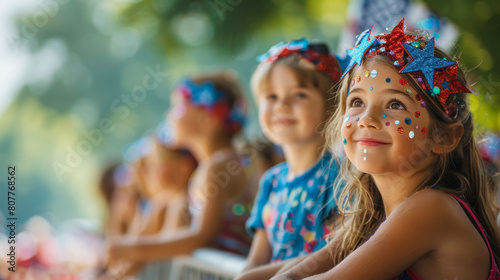 Smiling children wearing festive star-spangled headbands at a 4th of July celebration