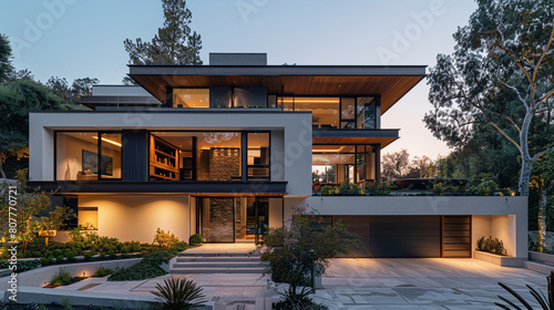 A modern house with a multi-angled roofline and a two-car garage with a private movie theater above,