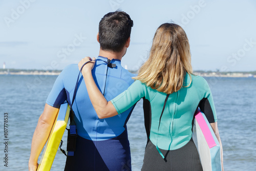 couple in love before surfing on the beach