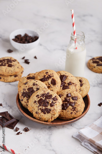 Butter cookies with chocolate chips served with glass of milk. Delicious homemade dessert.