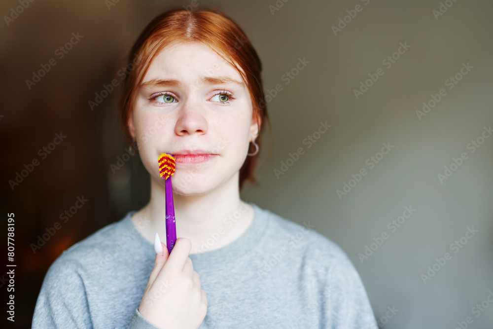 girl holds a toothbrush and thinks its time to replace it girl holds a toothbrush and thinks its time to replace it