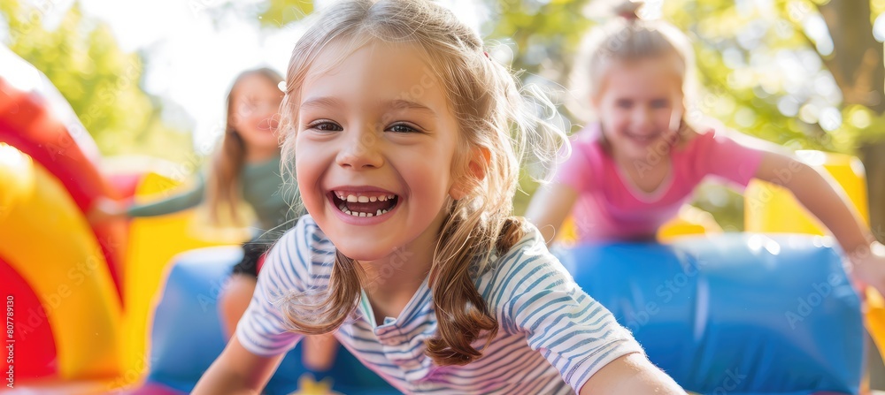 Very happy children are jumping on an inflatable bounce house during summer and pleasant weather. Very happy children are jumping on an inflatable bounce house during summer and pleasant weather.