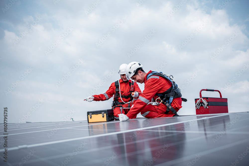 Obraz premium Engineers walking and holding box on factory roof inspection survey and check solar cell panel .Solar cell is smart grid sustainable ecology energy sunlight alternative power factory concept.