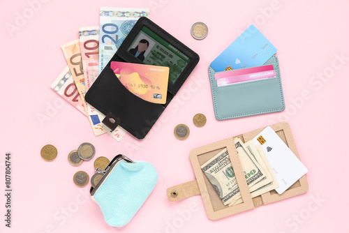 Composition with credit holders, cards, driver's license, purse and money on pink background, closeup