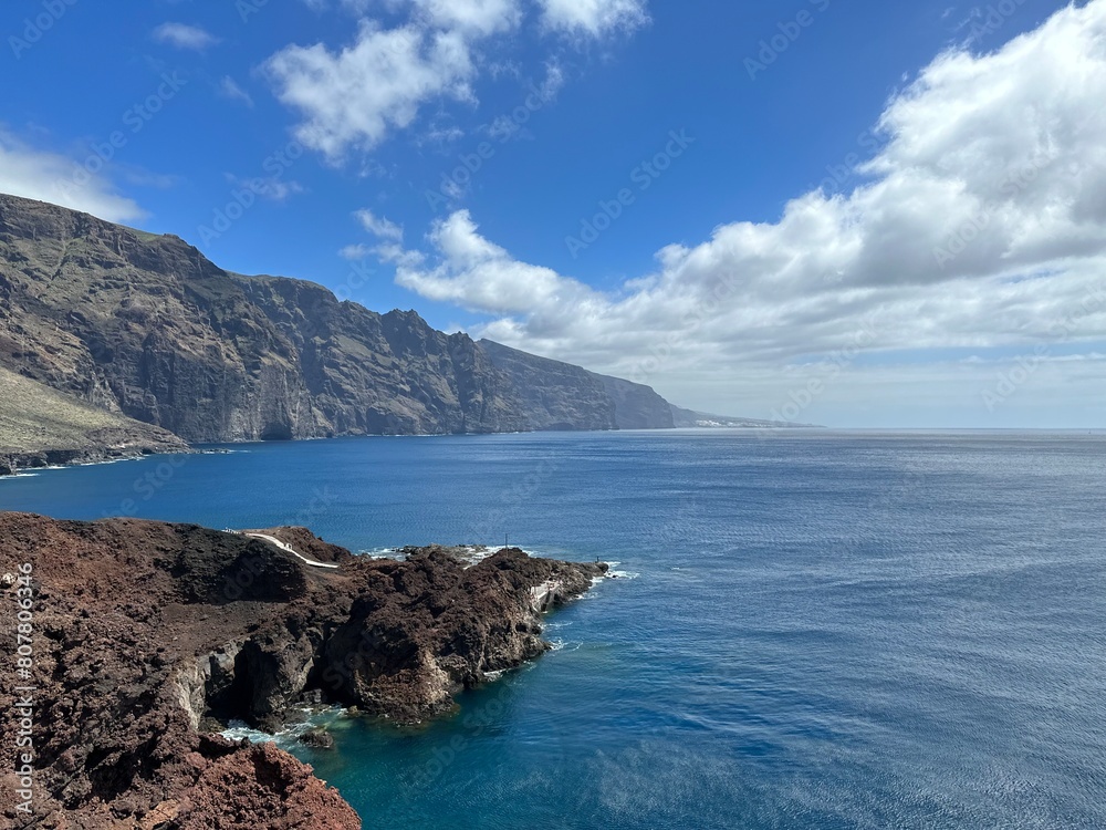 View of the Atlantic Ocean coast with Acantilados de Los Gigantes cliffs under the blue sky, Buenavista del Norte, Tenerife, Canary Islands, Spain, March 2023