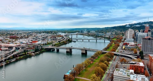 Beautiful view of the Willamette River crossing the landscape of Portland, Oregon, USA. Cloudy skies above the city panorama. photo