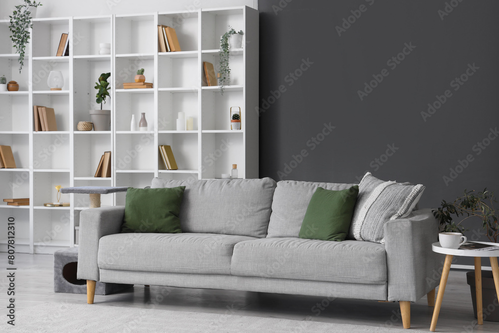 © Pixel-Shot - Interior of living room with grey sofa and bookshelf © Pixel-Shot - Interior of living room with grey sofa and bookshelf