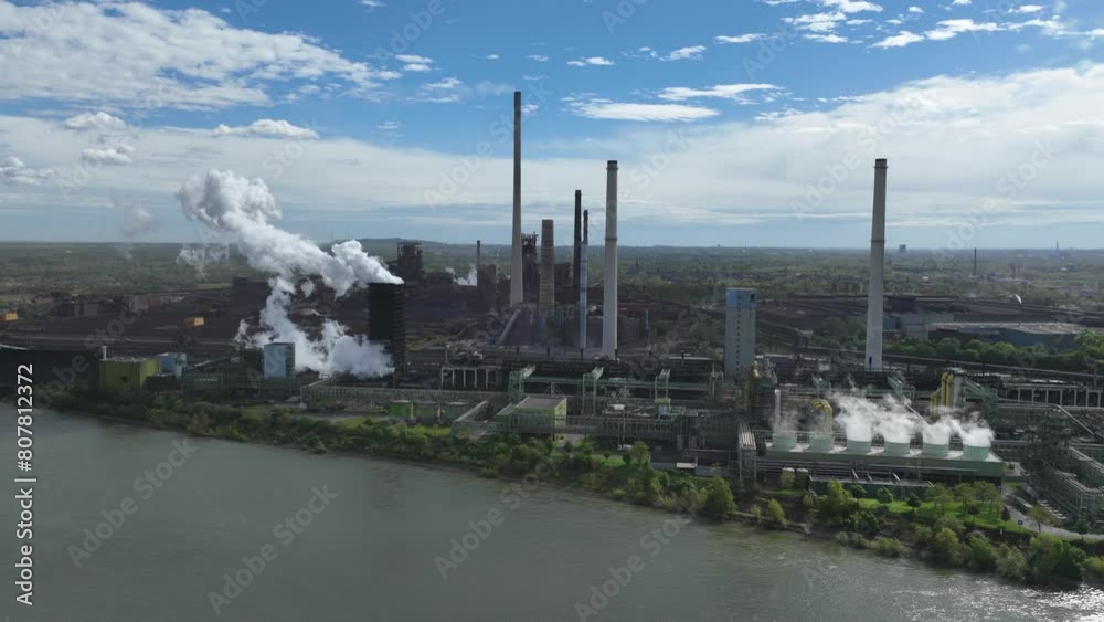 Coking plant Schwelgern, along the Rhine in Duisburg, one of the largest coking plants in the world. Steel production industry, aerial hyperlapse. Cooling of hot cokes.