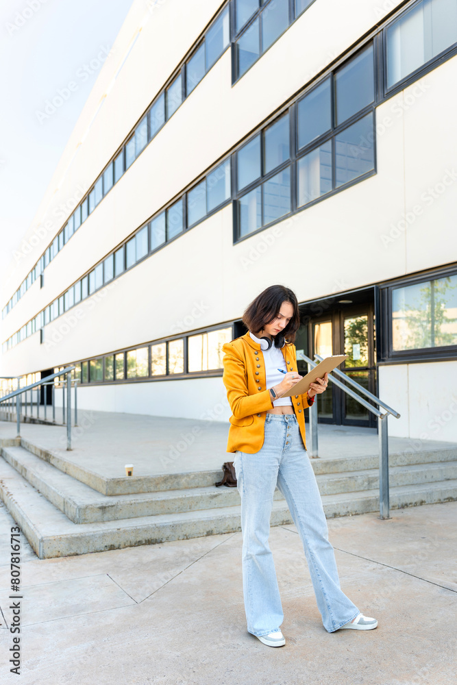 Romanian businesswoman checking company task list Romanian businesswoman checking company task list