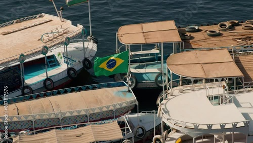 boat for carrying tourist with Brazilian flag in Aswan Dam and Lake Nasser, Egypt