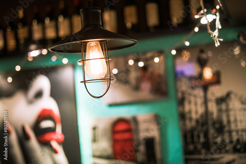 Dimly lit bar with hanging lights and relaxed patrons