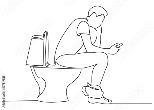 man on the toilet with a phone in his hands