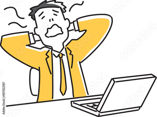ノートパソコンの前であくびをする会社員