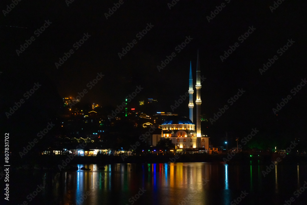 Illuminated mosque on Uzungol Lake at night, Turkey. Concept of travel, religion
