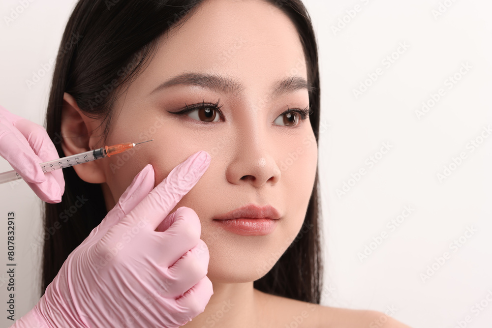 Woman getting facial injection on white background, closeup Woman getting facial injection on white background, closeup