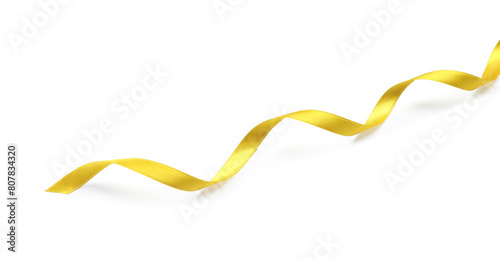 One golden satin ribbon on white background, above view