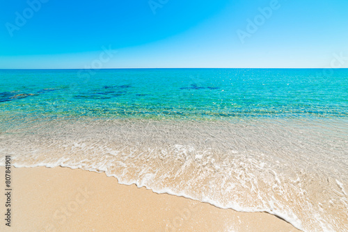 Beach with turquoise water and white sand on a sunny day