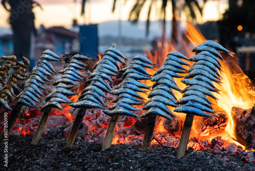 Sardines being griiled on the fire in traditional way in Malaga photo