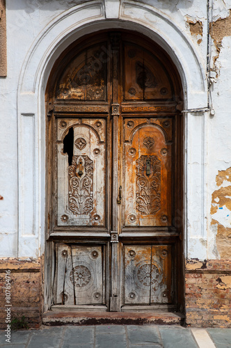 Old damaged wooden door in old house in Spain