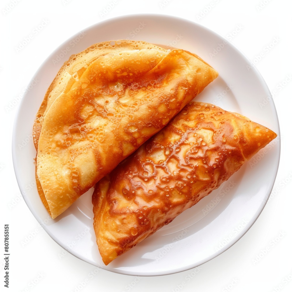 Two pieces of Chinese Jianbing Crepes served on a white plate