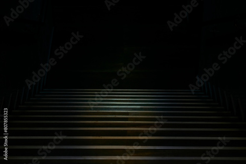 A wide staircase with metal rims leading into the gloomy darkness