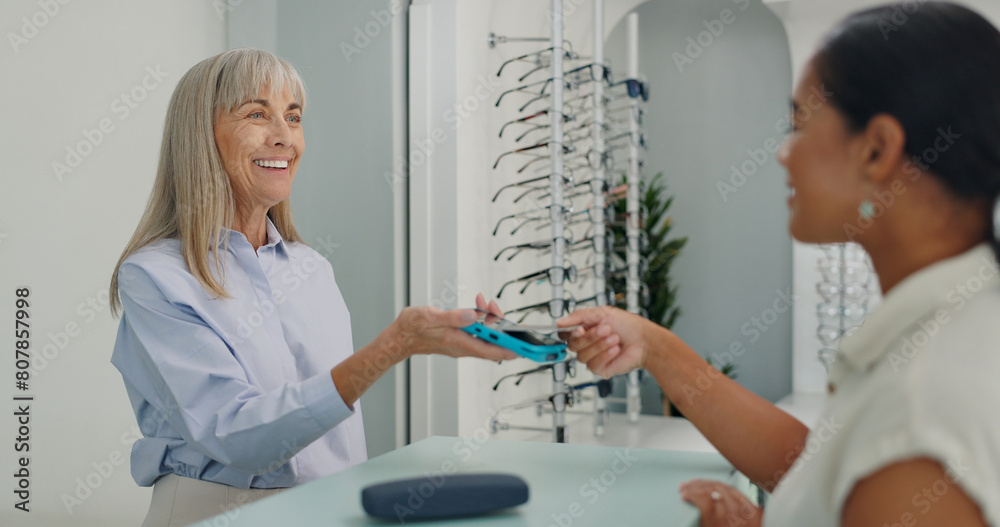 © peopleimages.com - Shopping, credit card and people with contactless payment for retail service and eye care at store. Tap, machine and optometrist with customer with bank purchase transaction at optical shop.