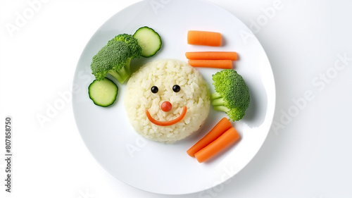 Funny food for children, cute rice with carrots and broccoli on a plate on a white background, a character with a smile and eyes photo