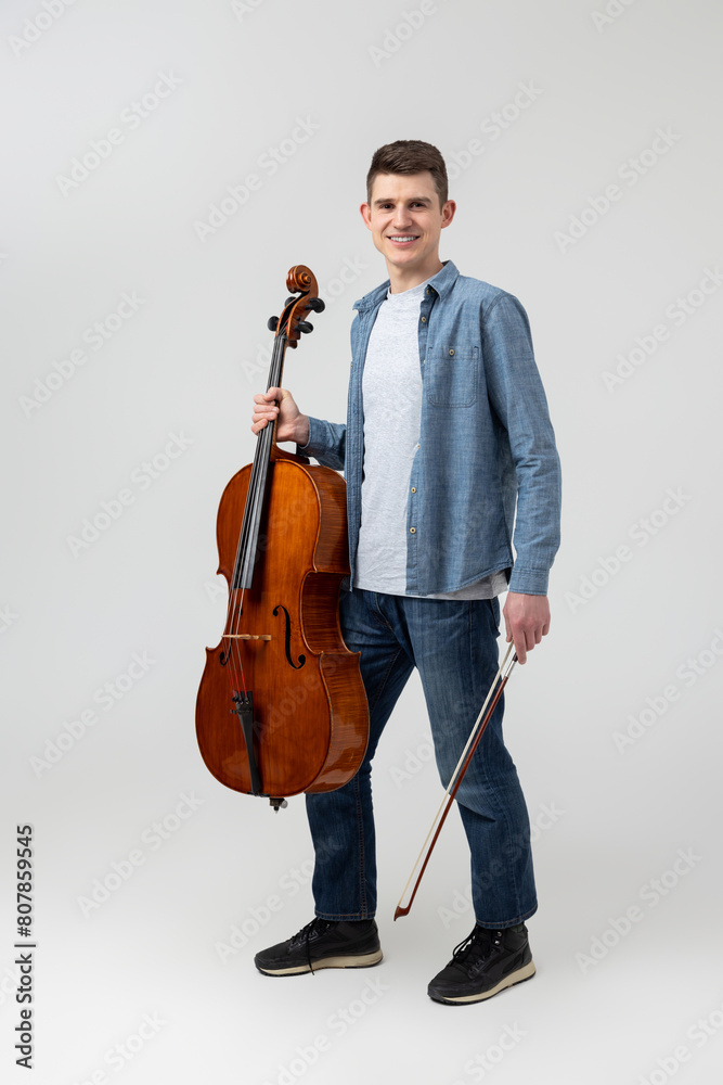 Attractive man musician playing cello on concert Attractive man musician playing cello on concert