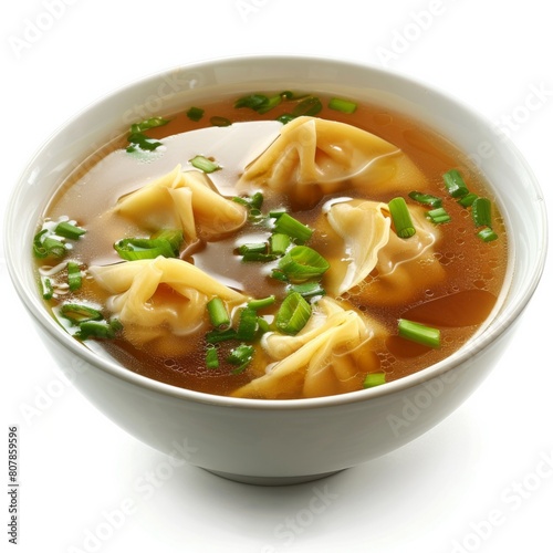 A bowl of soup filled with savory dumplings and topped with fresh green onions