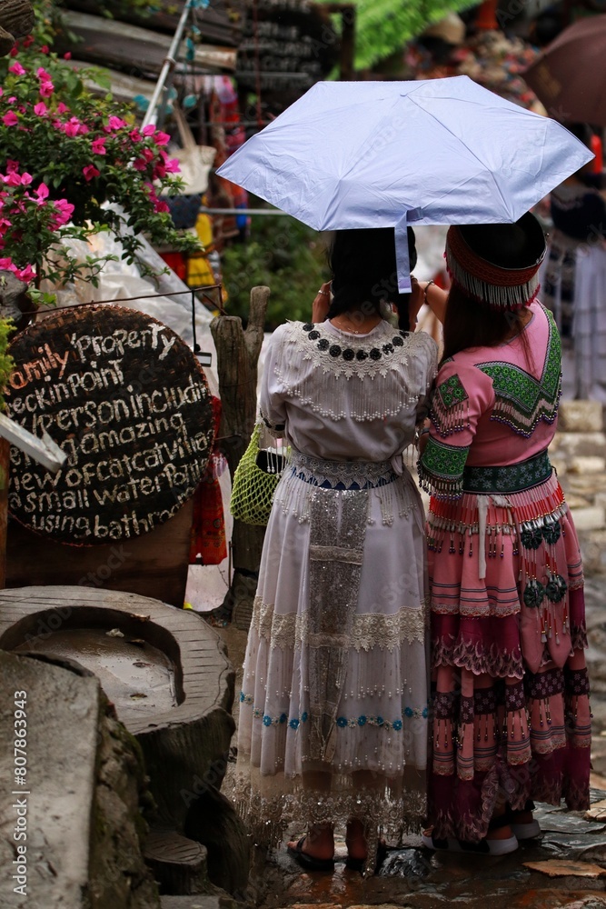 Beautiful Vietnamese women in the traditional dress and umbrella.