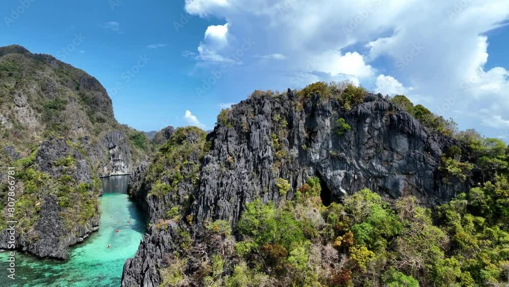 The Aerial view of white sand beach bathed by a crystal clear water. Entalula island, Bacuit Bay, El Nido, Palawan, Philippines. The Aerial view of white sand beach bathed by a crystal clear water. Entalula island, Bacuit Bay, El Nido, Palawan, Philippines.