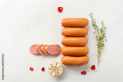 top view milk sausages and spices on light surface