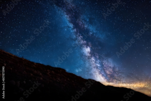 Cosmic Canvas. Vibrant Milky Way over tranquil hills  suitable for book covers  posters  or astronomy guides.