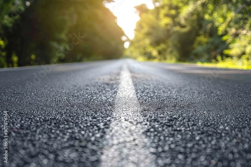 Captivating shot of an empty weathered road stretching towards a dramatic sunset horizon under a cloud-filled sky. Beautiful simple AI generated image in 4K, unique.