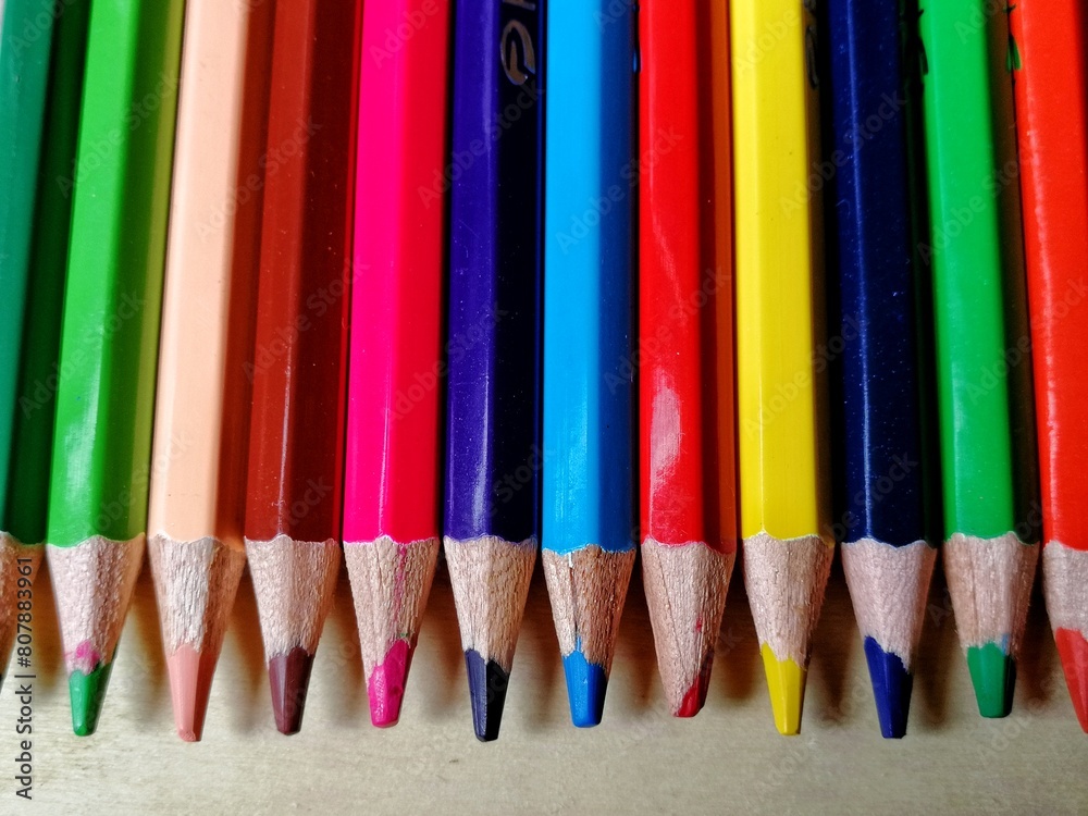 Colour pencils on the wooden board. Close up shot of colorful pencils Colour pencils on the wooden board. Close up shot of colorful pencils