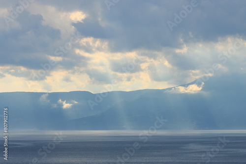 Cloudy day over sea with visible sunrays