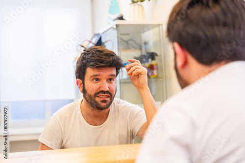 Photos Happy bald man with a new capillary prosthesis
