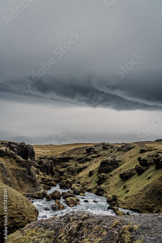 Skógá River under a stormy sky. Long river runs through the Highlands of Iceland, summer storm, climate change. Creation of the famous Skógafoss waterfall.