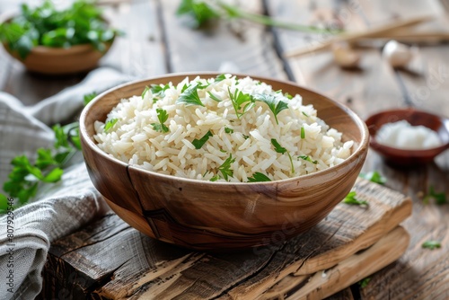 Bowl of rice with garlic and parsley on a wooden table