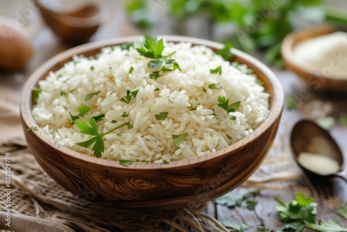 Bowl of rice with garlic and parsley on a wooden table