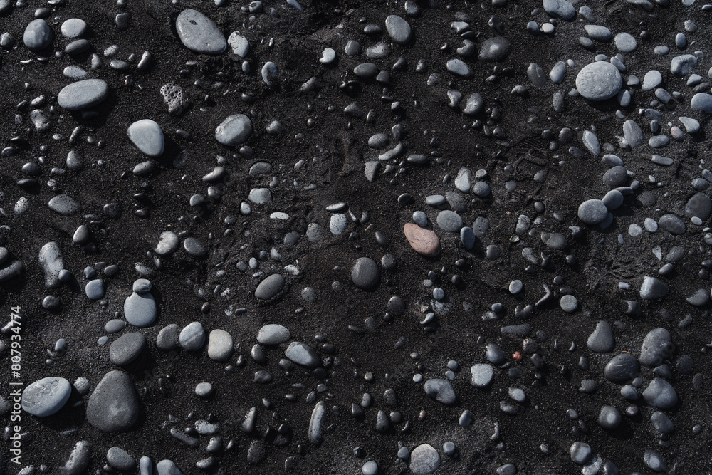 Texture of stones and black sand. Volcanic land, beach, natural pattern. Texture of stones and black sand. Volcanic land, beach, natural pattern.