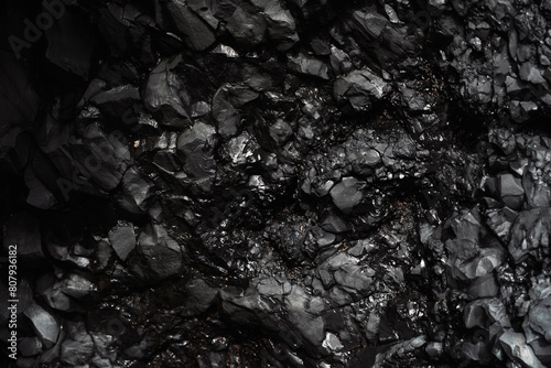 Wet basalitic rock texture. Pattern, geometry, geology, light reflections. Structure of rocks inside a cave. Icelandic black beach. photo