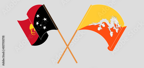 Crossed and waving flags of Papua New Guinea and Bhutan