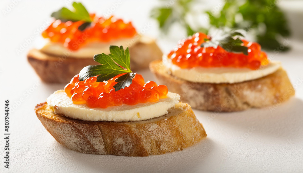 Bruschetta with cream cheese and red caviar on white table. Delicious snack. Tasty delicacy.