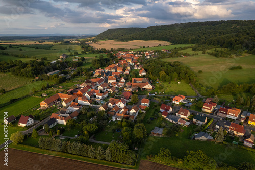 Aer ial view of a German village surrounded by meadows, farmland and forest. Thuringia, Germany. photo