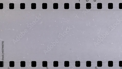 Damage to an old celluloid film strip. Tearing. Burning. Transition. Glitches. Overlay.